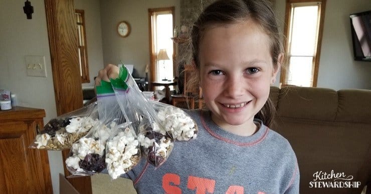 Leah holding trail mix packs