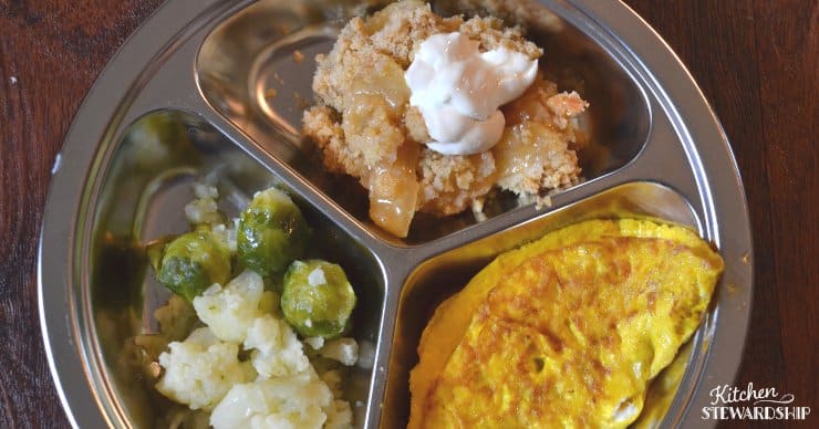 Veggies, apple crisp and an omlete on a plate