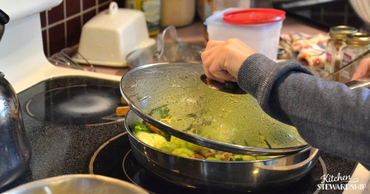 Kid cooking vegetables on a stove