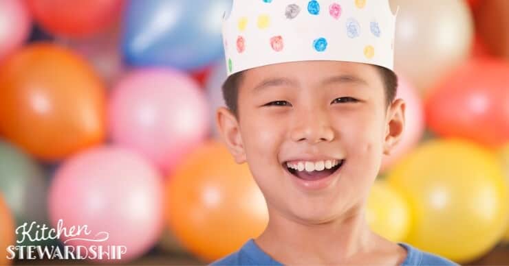 Boy in party hat, school birthday treats