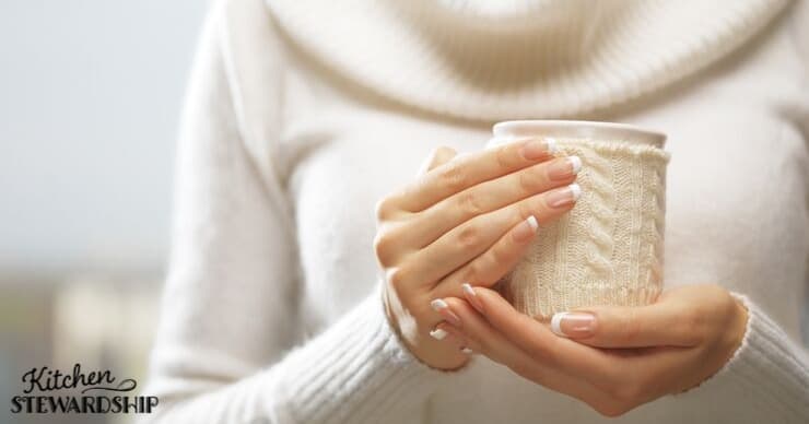 Woman holding cup of warm tea