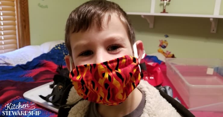 Boy in a dust allergy mask