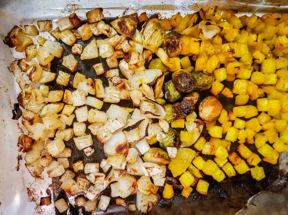 dill roasted mixed vegetables - golden beets, turnips, Brussels sprouts, onions in glass dish