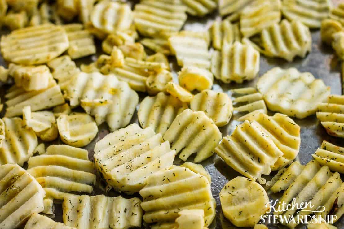 Parsnips roasting on a pan with dill 
