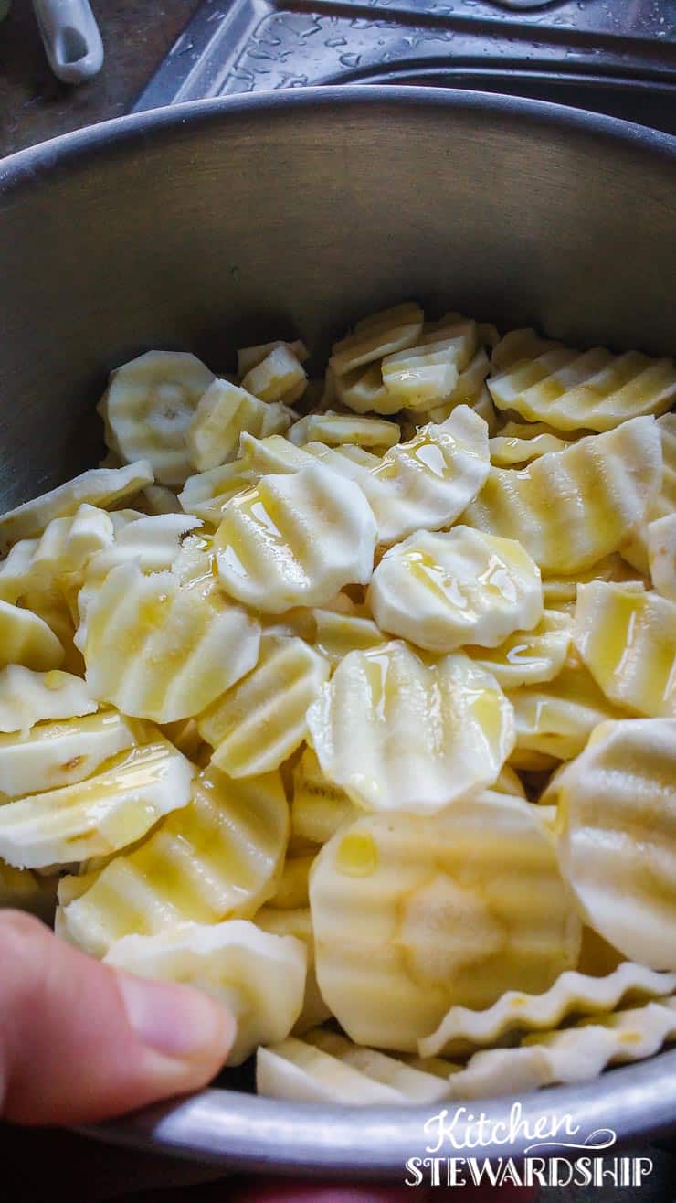 crinkle cut parsnips in a bowl with olive oil