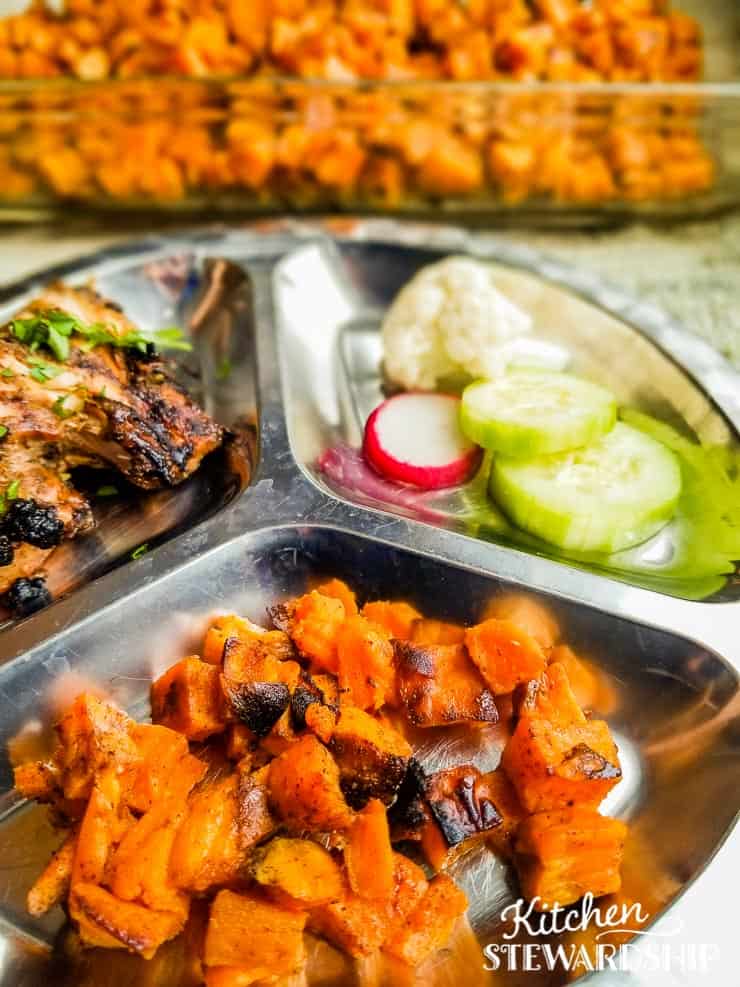 roasted sweet potatoes, chicken, cucumbers on metal plate