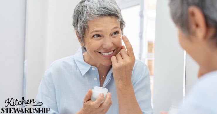 Woman using face moisturizer 