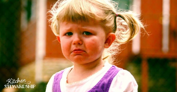 A toddler girl on the verge of tears