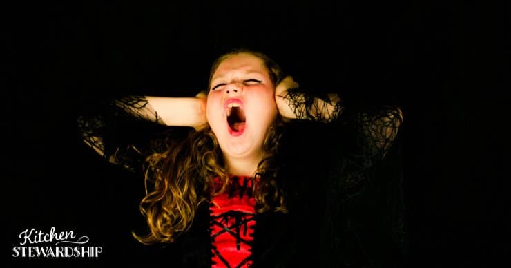 Young girl screaming in anger or 'hanger' with her hands over her ears