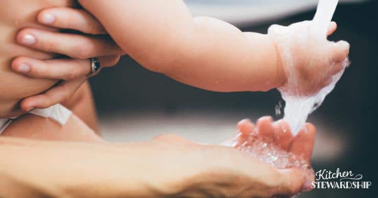 Close up of woman and baby washing hands