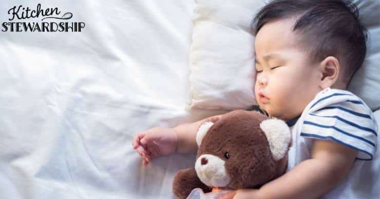 baby sleeping with teddy bear
