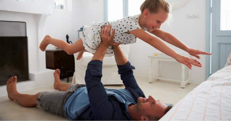 Father and daughter playing on floor in potentially polluted indoor air.