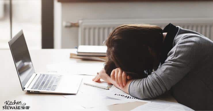 Sleep deprived woman asleep at laptop