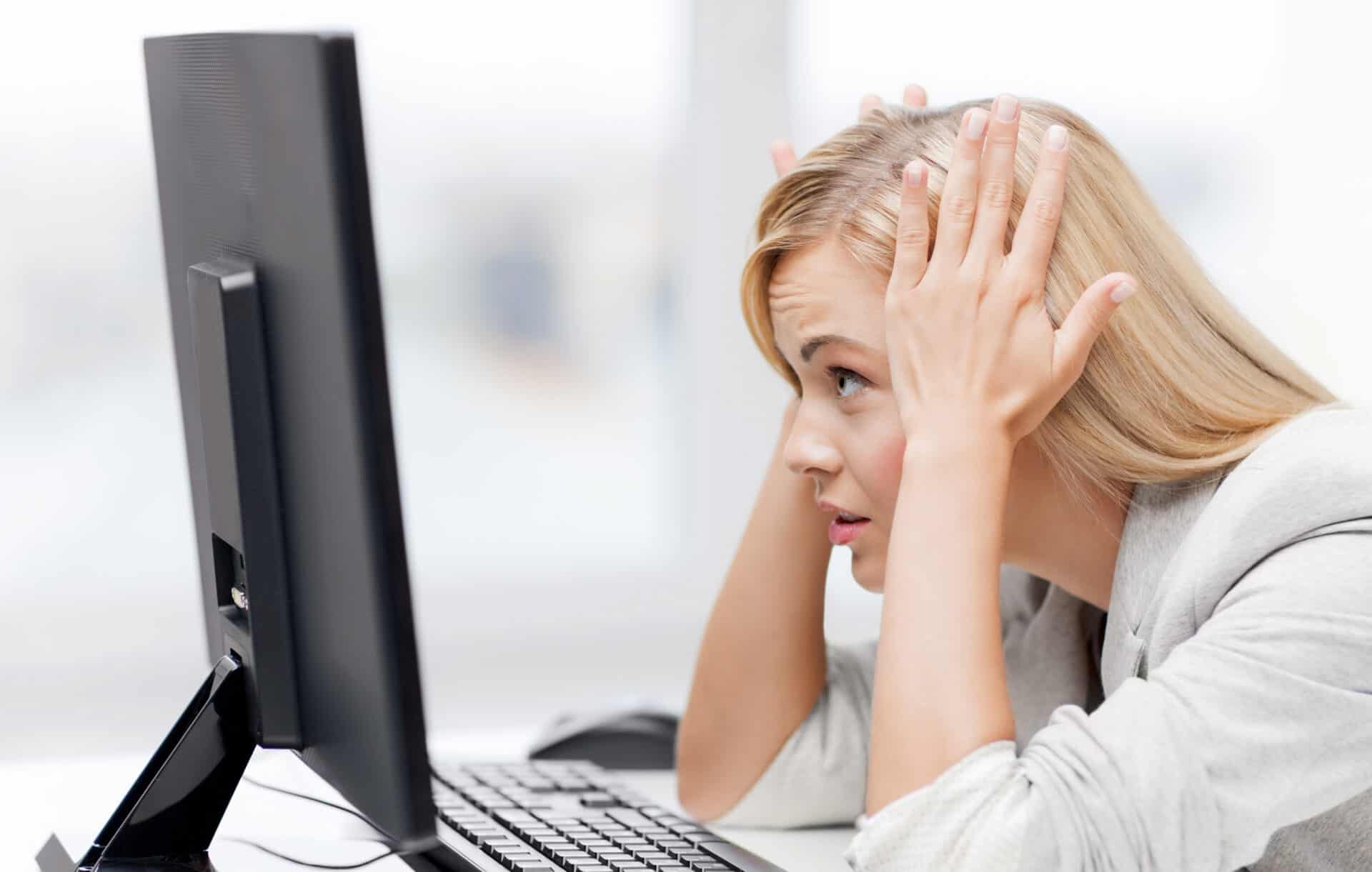stressed out woman looking at computer