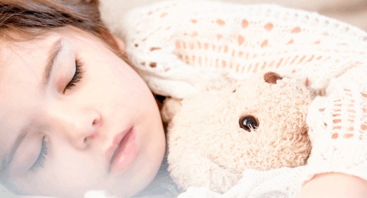 Sleeping toddler with teddy bear