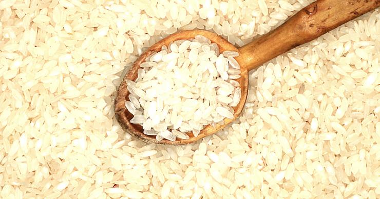 wooden spoon on a bed of brown rice