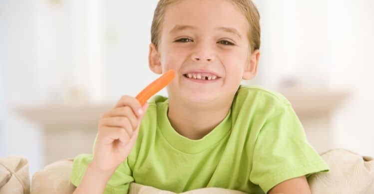 boy eating a carrot stick