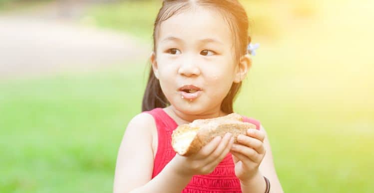 girl eating bread