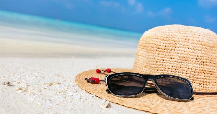 sunglasses and hat on the beach