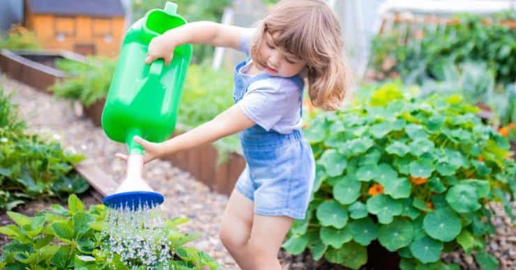 girl watering vegetables