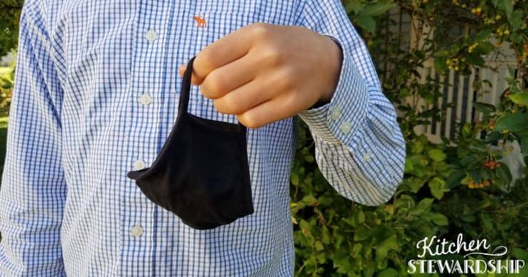 teen holding a face mask