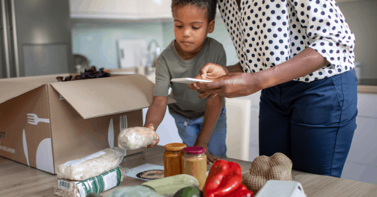 Kid unpacking a healthy meal subscription kit