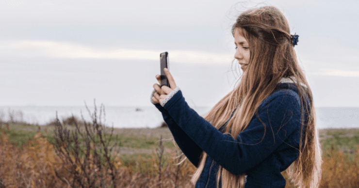 girl taking picture with phone