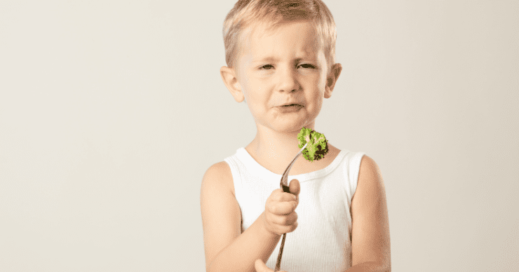 picky boy eating brocoli
