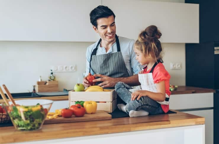 man and girl cooking