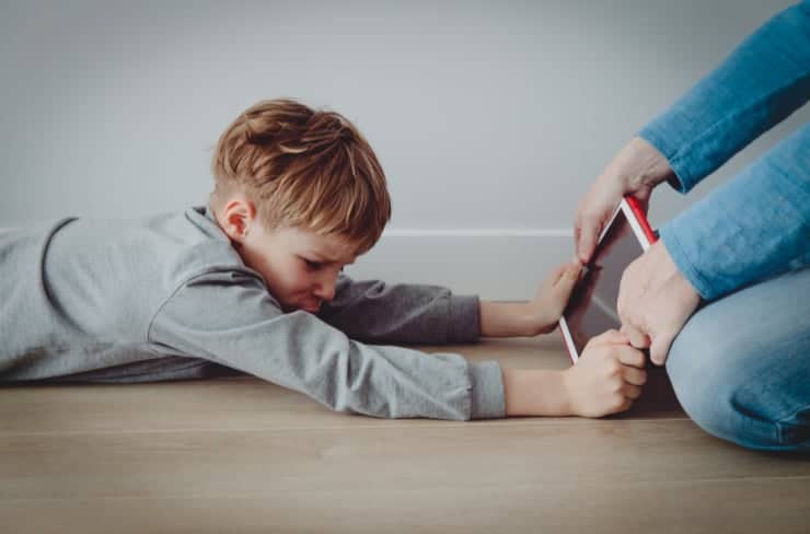 child pulling on tablet