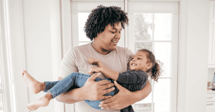 dad holding daughter