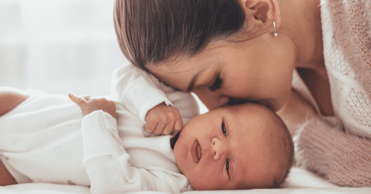 mother kissing baby