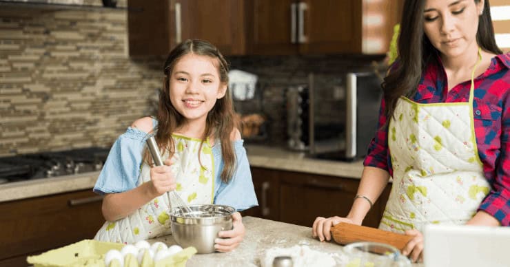 girl cooking with mom