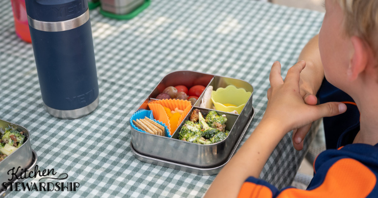 child with Bento box at table